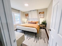 a bedroom with a bed and a bedside table