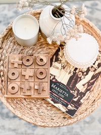 a wooden jigsaw puzzle and a book on a table